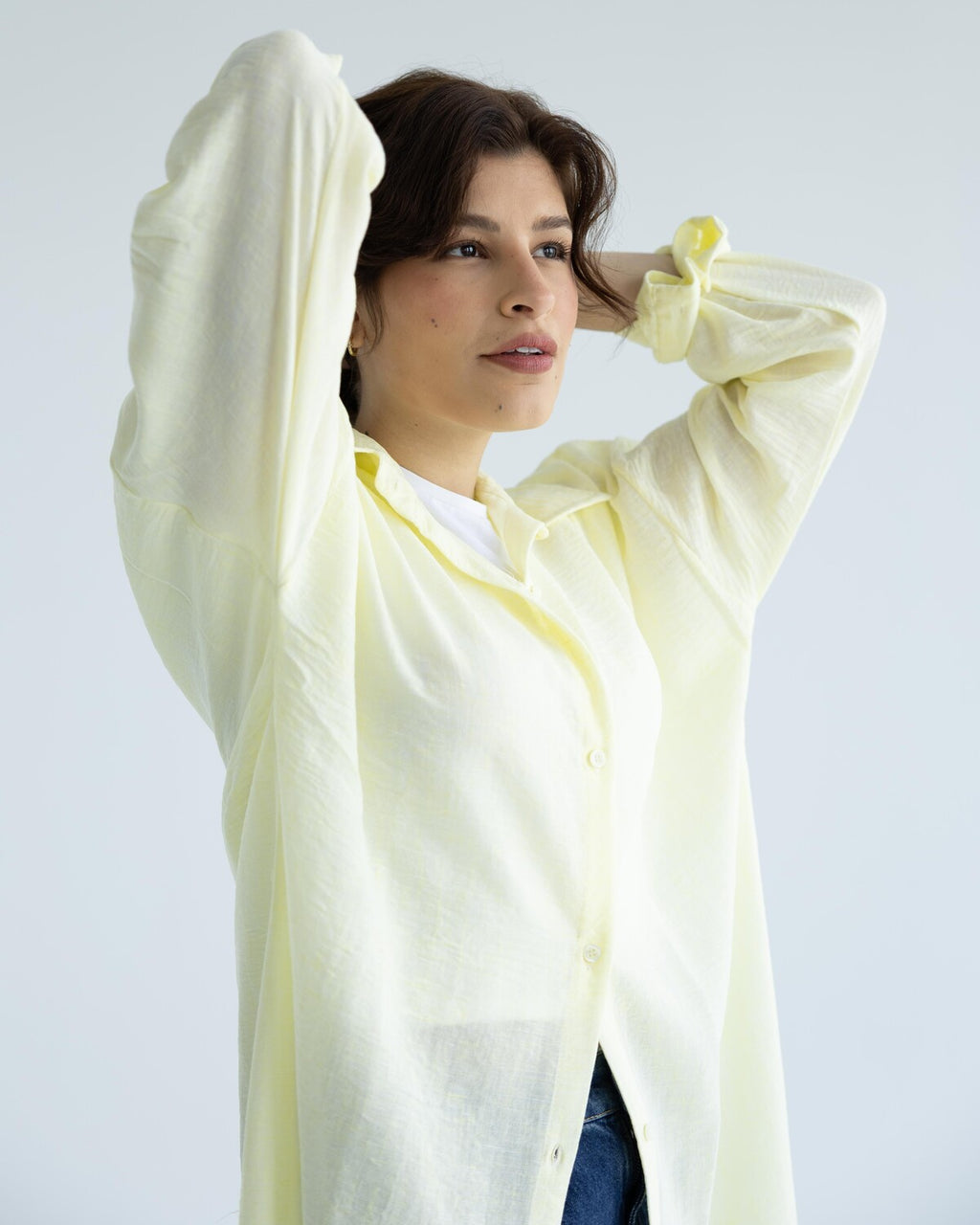 Woman wearing a light-yellow long shirt