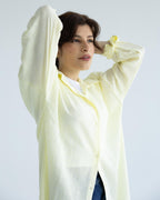 Woman wearing a light-yellow long shirt
